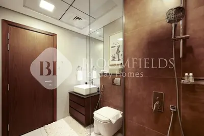 a bathroom with a shower and a toilet and a sink at Bloomfields Marquis 2020 in Arjan in Dubai