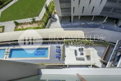 an overhead view of a swimming pool on a building at Bloomfields Marquis 2020 in Arjan in Dubai