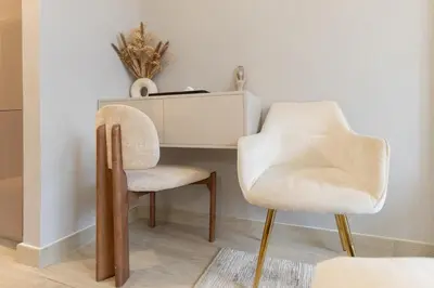 a desk and two chairs in a room at Downtown-Close Studio by Czech-In in Dubai