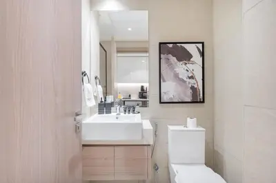 a white bathroom with a sink and a toilet at Downtown-Close Studio by Czech-In in Dubai