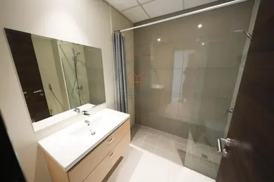 a bathroom with a shower and a sink and a mirror at Spacious Private 4-Bedroom Villa for Families & Groups in Dubai