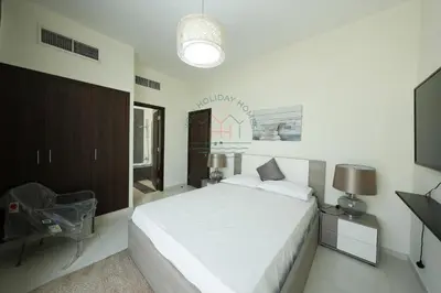 a white bedroom with a bed and a television at Spacious Private 4-Bedroom Villa for Families & Groups in Dubai