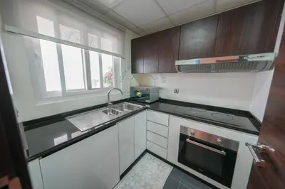 a small kitchen with a sink and a stove at Spacious Private 4-Bedroom Villa for Families & Groups in Dubai