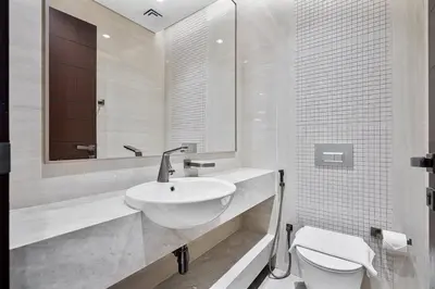 a white bathroom with a sink and a toilet at Relaxing 2BR in Business Bay Mins to Burj Khalifa in Dubai