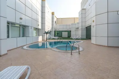 a building with a pool in the middle of a courtyard at Samaya Holiday Homes - Lake City Stunning Suits Lake View - Next to Metro in Dubai