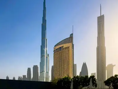 a group of tall buildings in a city at PVH - Emaar Residences - Burj Khalifa View Studio in Dubai