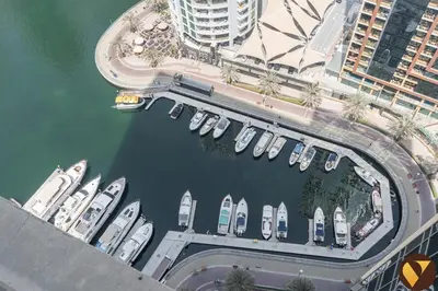 an overhead view of a marina with boats in the water at Vogue Marina JW Marriott with Direct Access to Marina Mall, Studio Apartment with Balcony and Marina Skyline View, Access to all Amenities in Dubai