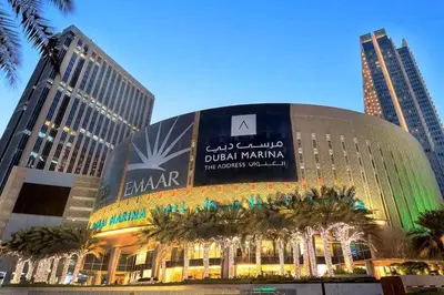 a building with a sign on it in a city at Vogue Marina JW Marriott with Direct Access to Marina Mall, Studio Apartment with Balcony and Marina Skyline View, Access to all Amenities in Dubai