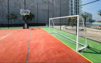 a basketball court with a net and a goal at Vogue Al Maktoum City, District One Residence, within a short drive from Downtown Burj Khalifa and Dubai Mall, Three Bedroom Apartment plus Kids Room with Large Balcony in Dubai