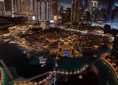 an aerial view of a city at night at Iconic Burj Khalifa & Fountain Views, Luxury 2BR Downtown in Dubai