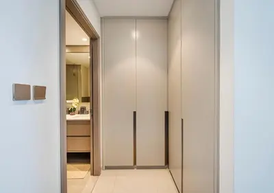 a walk in closet in a bathroom with white walls at Iconic Burj Khalifa & Fountain Views, Luxury 2BR Downtown in Dubai