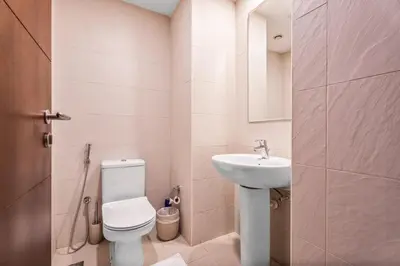 a small bathroom with a toilet and a sink at Boema Apartments- Luxury with Burj Khalifa View in Dubai
