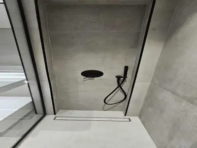 a shower in a bathroom with a shower head at Beautiful Studio in Jumeirah Village Circle in Dubai