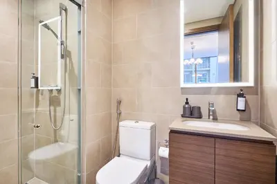 a bathroom with a toilet and a sink and a shower at STAY BY LATINEM Luxury 2BR Holiday Home CVR B405 Near Burj Khalifa in Dubai
