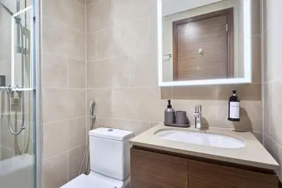 a bathroom with a toilet and a sink and a shower at STAY BY LATINEM Luxury 2BR Holiday Home CVR B405 Near Burj Khalifa in Dubai