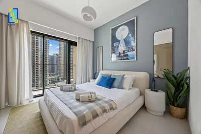 a bedroom with a large bed and a large window at The Ivory Crown 1BR Downtown Dubai in Dubai