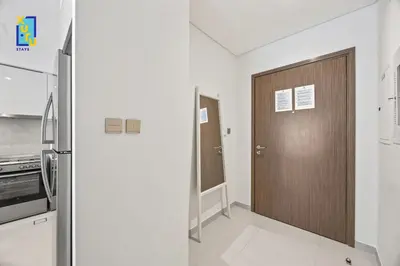 a kitchen with a wooden door in a room at The Ivory Crown 1BR Downtown Dubai in Dubai
