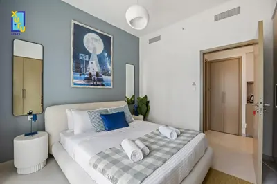 a bedroom with a white bed with towels on it at The Ivory Crown 1BR Downtown Dubai in Dubai