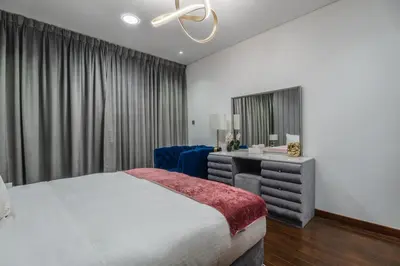a bedroom with a bed and a desk and a chair at 83rd Floor Luxurious Penthouse Full Sea View 6 BHK in Dubai