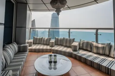 a living room with couches and a table at 83rd Floor Luxurious Penthouse Full Sea View 6 BHK in Dubai