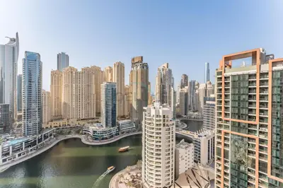 a view of a city with a river and buildings at Luxury 1BR with Breathtaking Dubai Water Canal Views, Just Beside Dubai Marina Mall and Tram, Near JBR Beach, The Address Residences, Dubai Marina by Deluxe Holiday Homes in Dubai