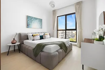 a bedroom with a bed and a couch and a window at Stylish 1BR with Balcony and Burj AlArab View in Dubai