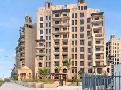 a large apartment building with two tall buildings at Stylish 1BR with Balcony and Burj AlArab View in Dubai