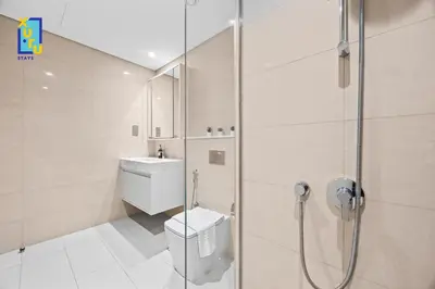 a bathroom with a shower and a toilet and a sink at Celestial & Curated 1BR Downtown Dubai in Dubai