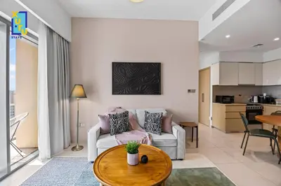 a living room with a couch and a table at Celestial & Curated 1BR Downtown Dubai in Dubai