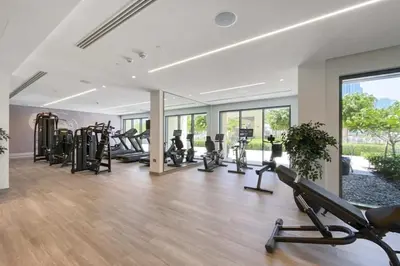 a gym with a bunch of treadmills and ellipticals at Celestial & Curated 1BR Downtown Dubai in Dubai
