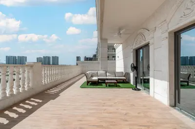 a balcony with chairs and a table on a building at Elegant 2Bhk Panorama Apartment in Dubai