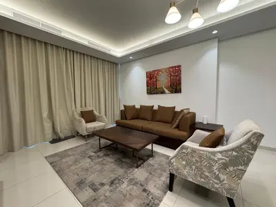 a living room with a couch and a table at Paramount Hotel Midtown 2BR Apartment With Burj Khalifa View in Dubai