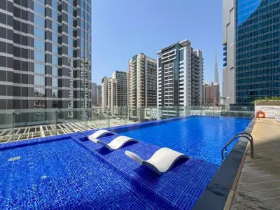 a swimming pool on the roof of a building at Waves - Vibrant Studio, Perfect For Couples in Dubai