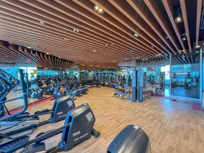 a gym with many treadmills and elliptical machines at Waves - Vibrant Studio, Perfect For Couples in Dubai