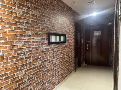 a brick wall with a television attached to it at Affordable Hostel in Al Barsha 1 Near Mall of Emirates Metro in Dubai