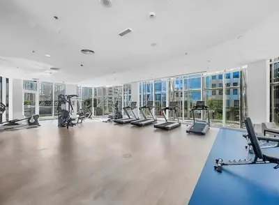 an empty gym with treadmills and elliptical machines at The Pad luxury 1BR with full Canal View in Dubai