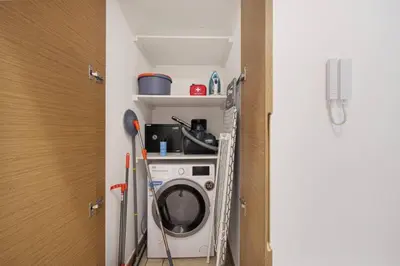 a washer and dryer in a small room at Moon Stays - Canal View- 2BR Missoni Stay in Dubai