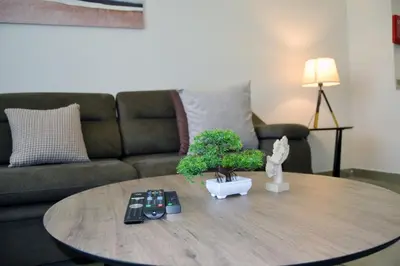 a coffee table in a living room with a couch at Cozy spacious Modern 1 bedroom Apartment in Dubai