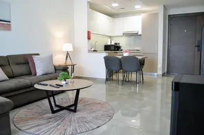 a living room with a couch and a table at Cozy spacious Modern 1 bedroom Apartment in Dubai