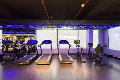 a gym with several treadmills and machines in it at New Studio in JVC - Hamilton House at 5th floor in Dubai