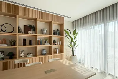 a dining room with a table and a large window at New Studio in JVC - Hamilton House at 5th floor in Dubai