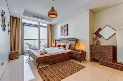 a bedroom with a large bed and a large window at Paramount Towers & Residences - 1 Bedroom Apartment - Allsopp & Allsopp in Dubai