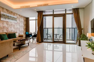 a living room with a couch and a table at Paramount Midtown - 1 Bedroom Apartment - Allsopp & Allsopp in Dubai