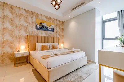 a bedroom with a large bed and a window at Paramount Midtown - 1 Bedroom Apartment - Allsopp & Allsopp in Dubai