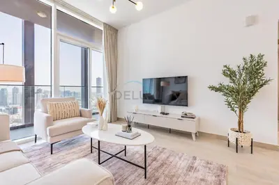 a living room with a couch and a tv at Stay Near the Park with Easy Exit from JVC, Just Minutes to Dubai Marina and Palm Jumeirah - Bloom Towers A, JVC by Deluxe Holiday Homes in Dubai
