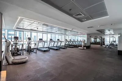 a gym with treadmills and exercise equipment in a building at Spacious 2BR Dubai Marina & City Views in Dubai