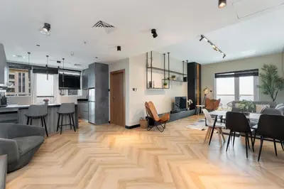 a living room with a table and chairs and a kitchen at Spacious 2BR Dubai Marina & City Views in Dubai