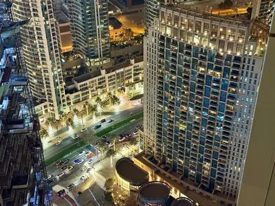 an aerial view of a city at night at Balcony Bliss 1BR with City View Pool & Gym in Dubai