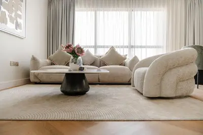 a living room with a couch and a coffee table at Elegant 2-Bedroom Apartment with Breathtaking Cityscape in Dubai