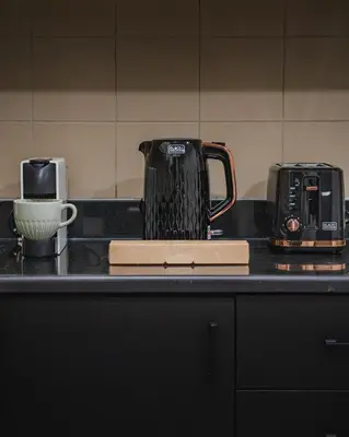 a kitchen counter with two appliances on a counter top at Elegant 2-Bedroom Apartment with Breathtaking Cityscape in Dubai